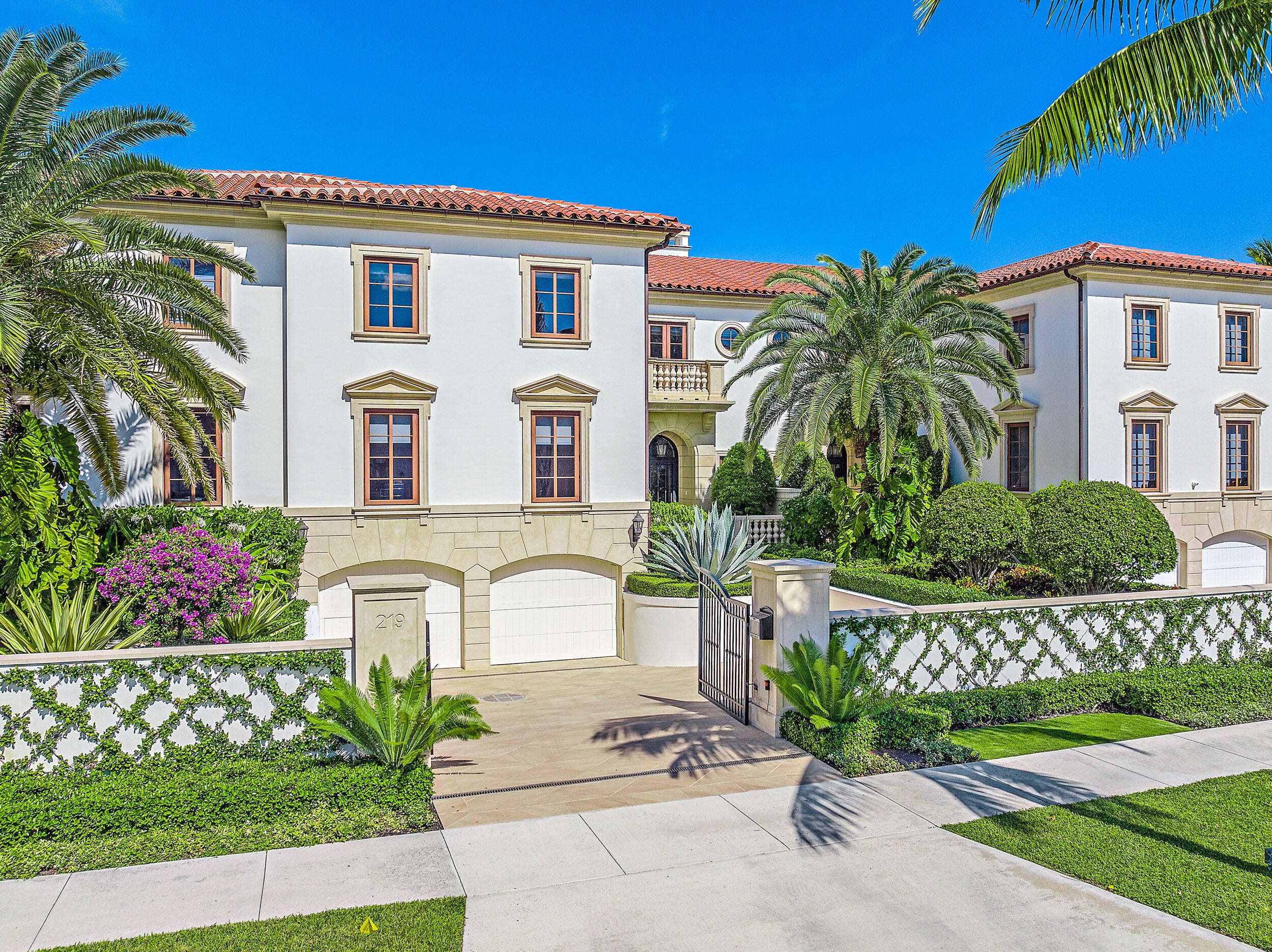 Palm Beach villa exterior with stone entry and paving